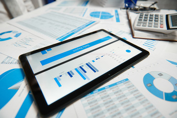 Office workspace for business. Tablet pc and reports. Table closeup. Business financial accounting...