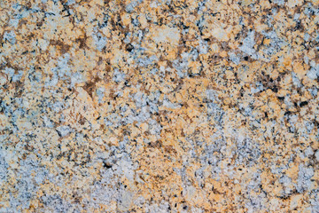 Yellow and grey granite wall with quarts and smooth surface as background