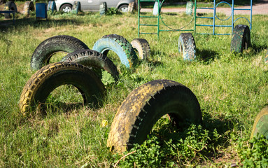 Fototapeta na wymiar old tires dug into the ground