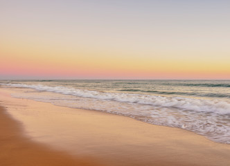 Obraz premium Faro Beach at sunset, Ilha de Faro, Ria Formosa Natural Park, Faro, Algarve, Portugal