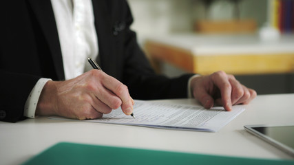 Man sign documents turning over the sheets. UHD