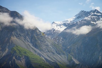 Seagulls soaring in the sky over mountains in Alaska 