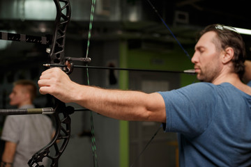 A man in a blue t-shirt with a bow.