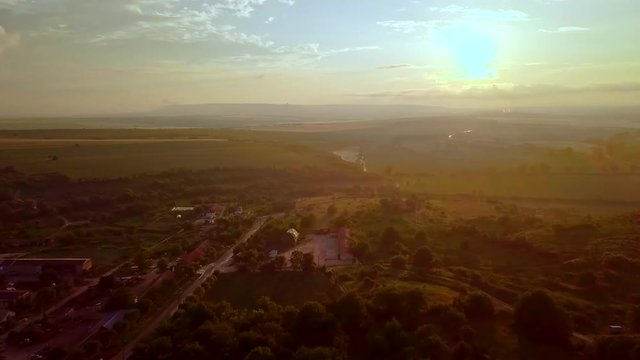 Sunset over low mountains and village