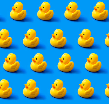 Seamless Pattern Rubber Ducks On A Blue Background