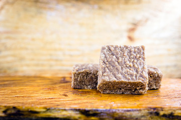 Sweet pele foot, sweet peanut typical of Brazil, state minas gerais. Brazilian sweet ground peanut, on table of emadeira, space for text.