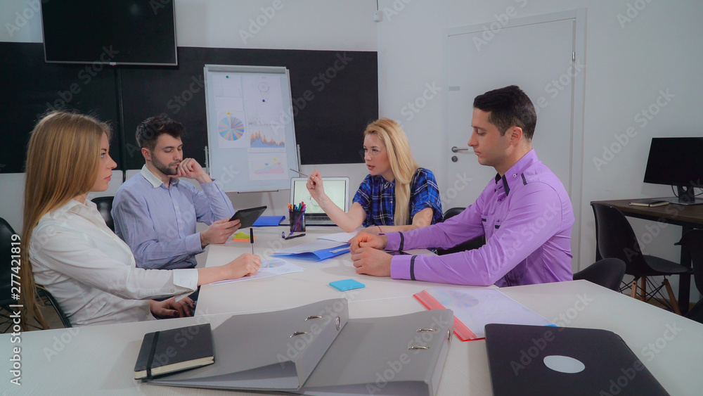 Aufkleber young diverse business team sitting in the boardroom. group of people discussing new project holding
