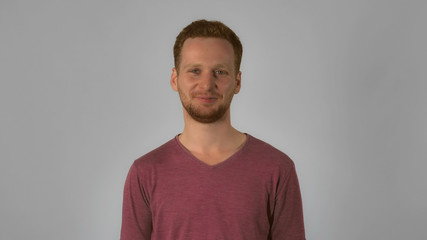 caucasian guy with red hair showing emotion joy. handsome redheaded men wearing in casual t-shirt laughing looking at the camera. Portrait smiling ginger young caucasian man on grey background