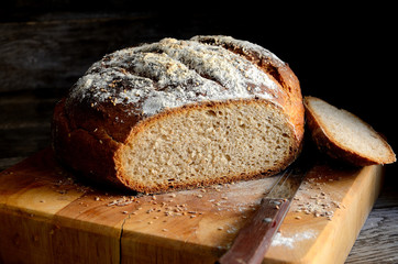 Sliced homemade rustic bread on a wooden table.
