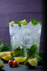 Mojito refreshing summer cocktail. Ingredients: ice, soda, rum, sugar syrup, lime, mint.