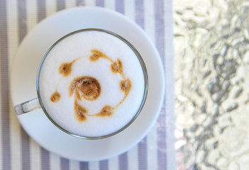 Cup of latte on glass table. Latte Art. 