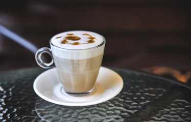 Cup of latte on glass table. Latte Art. 