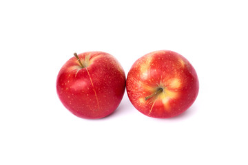 Two red apples on a white background. Juicy apples of red color with yellow specks. Fruit is ripe and juicy on a white background.