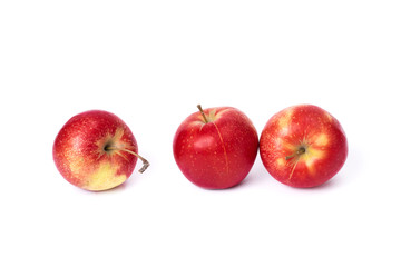Fototapeta na wymiar Three red apples on a white background. Juicy apples of red color with yellow specks on a white background. A group of ripe apples on an isolated background.