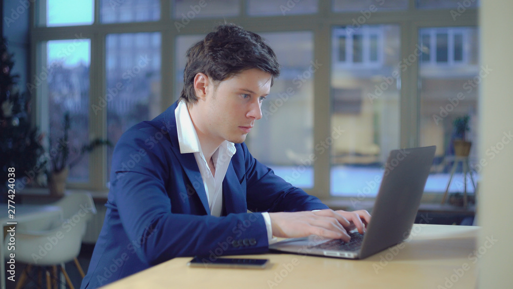 Poster portrait businessman focused on work. handsome professional man typing fast on laptop. caucasian mod
