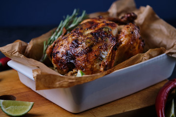 Chicken baked in the oven with spices, lemon, herbs and young potatoes.