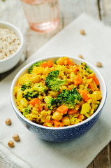 Quinoa broccoli carrot curry on a wood background