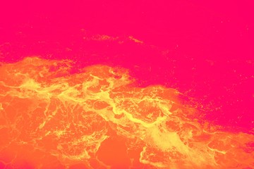 Boat wake photo done in neon bright colors for abstract effect