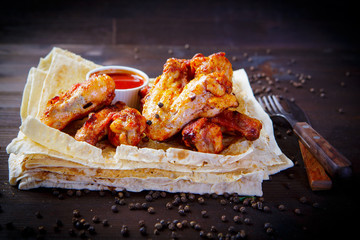 Chicken wings. Grill dishes for the restaurant menu. Wooden background