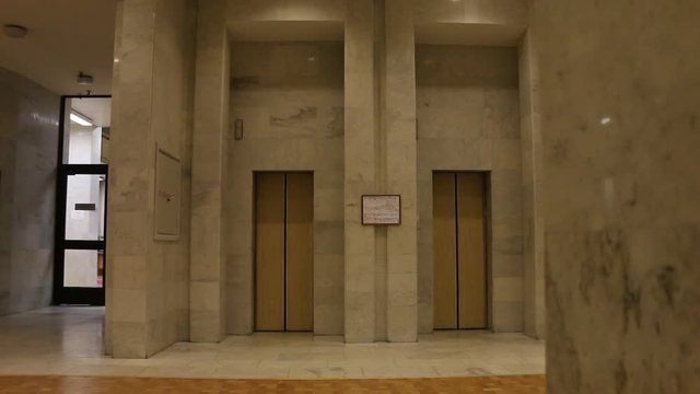 elevator doors open and close on an empty floor