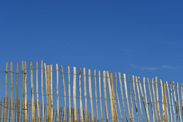 Picket fence, U.K. Simple barrier and blue sky.