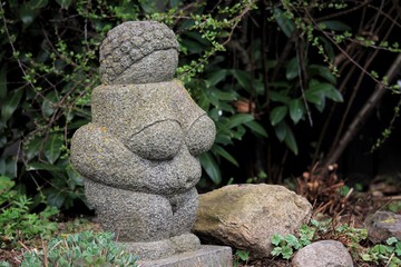 A statue replica of the ancient ”Venus from Willendorf” in a swedish garden in the spring...