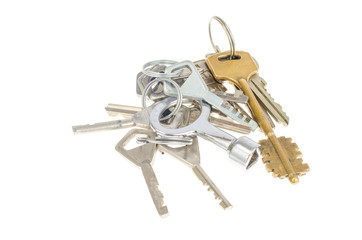 Bundles of old keys on white background.