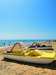 beach transport. yellow catamaran on the sand