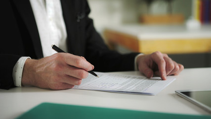 Man sign documents turning over the sheets. UHD