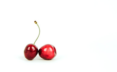 Sweet cherries on a white, isolated background. The concept of eating fruits, eating cherries. Red cherries, insulated cherries. A balanced diet, providing vitamins.