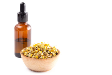 Chamomile Essential Oil with Dried Chamomile Flowers Isolated on a White Background
