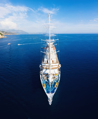 Yacht on the water surface from top view. Blue sea water background from top view. Summer seascape...