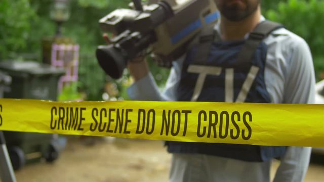 camera guy with an eng broadcast crime scene