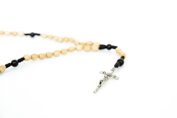 Rosary on a white, isolated background. The concept of Christian faith, Catholicism. Pray for grace, faith in God. Problems of the Catholic church, priests' blemishes.