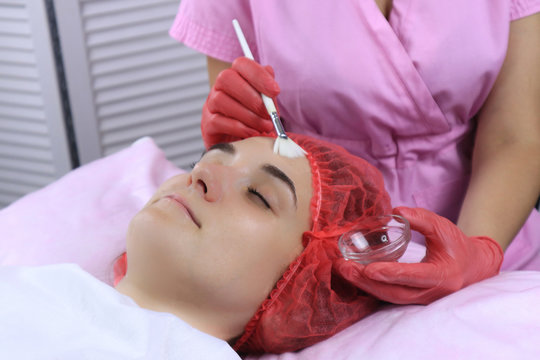 Young woman during cosmetologic procedure in beauty salon