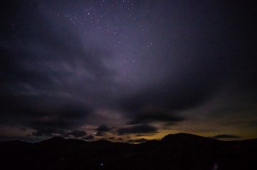 Starry sky at night over the mountains in the Carpathians