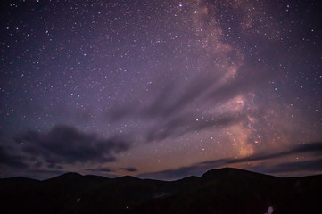 Clouds in the night sky against the background of the Milky Way © onyx124