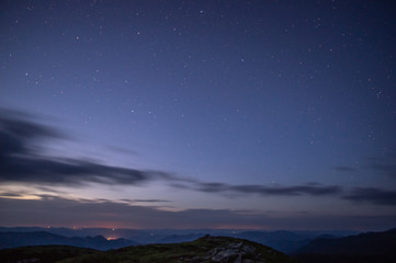 Fototapeta premium Stars in the predawn sky above the mountains