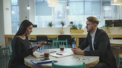 Business Partners at the meeting. Lady discusses strategy with a man. UHD video