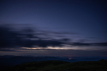 Stars in the predawn sky above the mountains