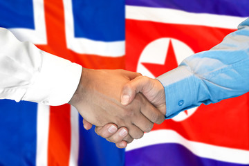 Business handshake on the background of two flags. Men handshake on the background of the Iceland and North Korea flag. Support concept