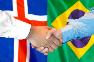 Business handshake on the background of two flags. Men handshake on the background of the Iceland and Brazil flag. Support concept