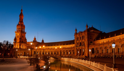 Seville, Spain. Spanish square during the blue hour. Golden palace illuminated by lampposts
