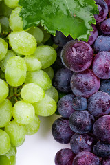 green and wine grapes on white background