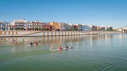 Seville, Spain. View of the Guadalquivir river. Generic canoeists train on the river. Seville is a...