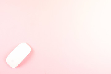 White laptop mouse over pink background.