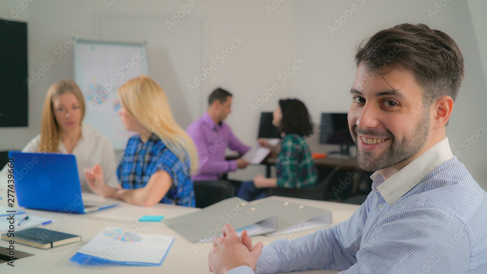 Aufkleber portrait handsome mixed race man in office startup company. young businessman looking at the camera 