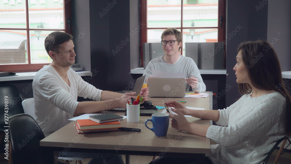 Aufkleber happy professional group of people sitting at the working place in contemporary office. young smilin