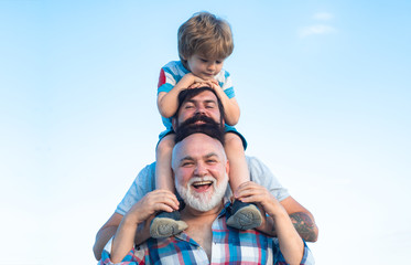Happy man family have fun together. Fathers day - grandfather, father and son are hugging and...