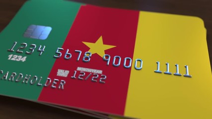 Plastic bank card featuring flag of Cameroon. Cameroonian national banking system related animation - Powered by Adobe